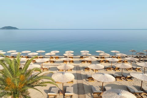 On the beach, white sand, sun loungers, beach umbrellas