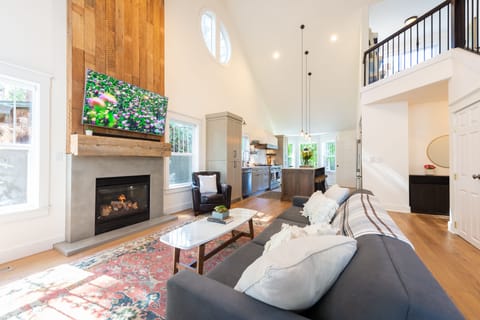 Completely remodeled living area and kitchen with soaring ceilings.