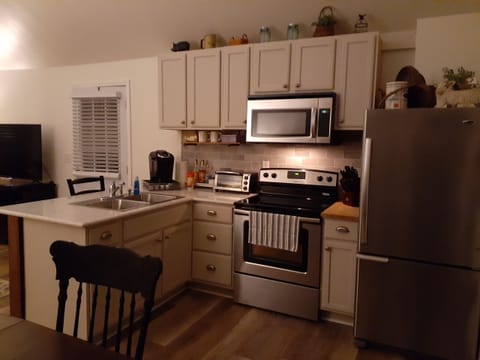 Kitchen with countertop bar and stainless appliances