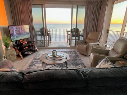 Living Room looking out from both sets of slider doors to the ocean.