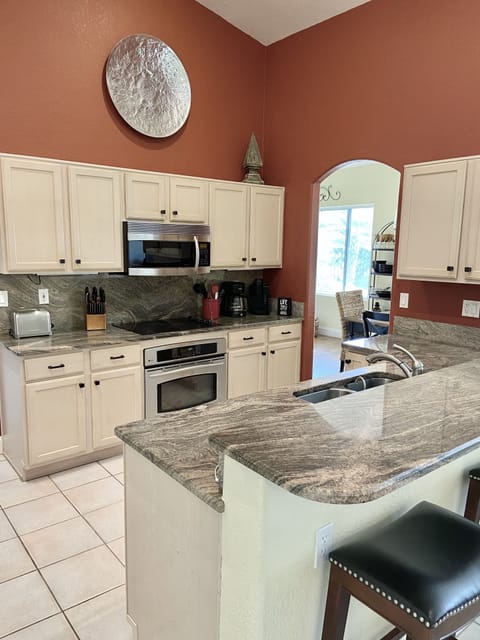 Fully stocked with gleaming granite counters and stainless steel appliances. 