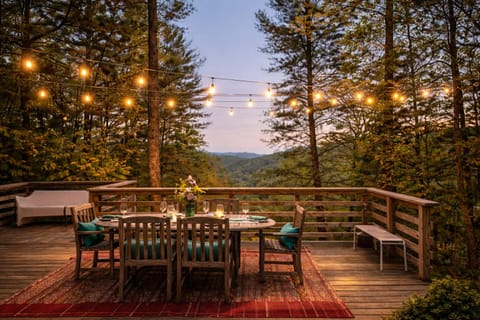South Deck with dining table for 6, lighting, lounge chairs & seating , a private courtyard and custom made fire pot all that overlook the mountains while listening to the rushing of the river down below.