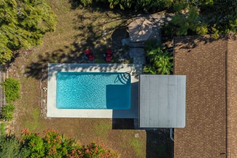 Large, private outdoor pool in fenced-in yard.