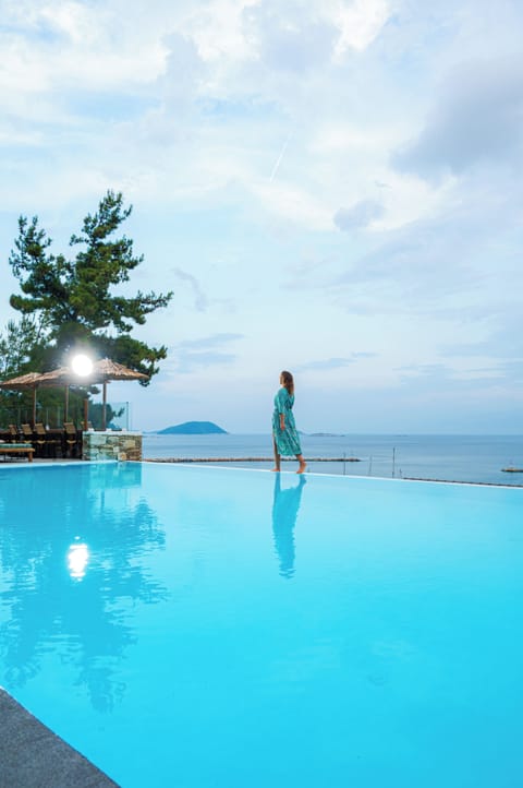 Seasonal outdoor pool, open 11:00 AM to 7:00 PM, pool umbrellas