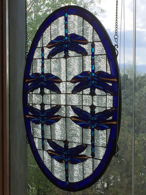 Stained glass blue dragonflies in upstairs queen bedroom overlooks corral