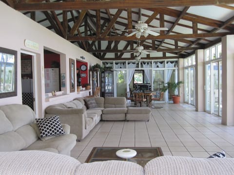 Huge living area overlooking ocean & pool. 2 sectionals & table. 4 ceiling fans.