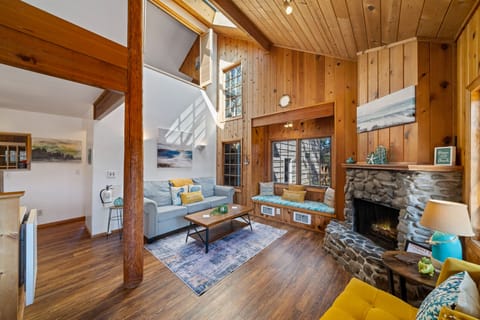 The family room is adjacent to the kitchen with a fireplace with candles. 