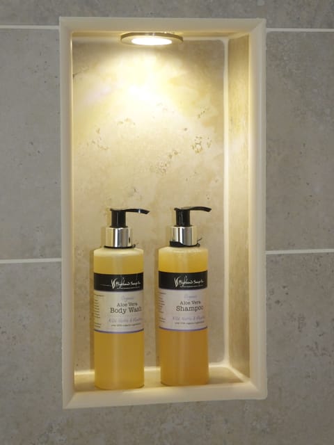 Shower, designer toiletries, hair dryer, towels