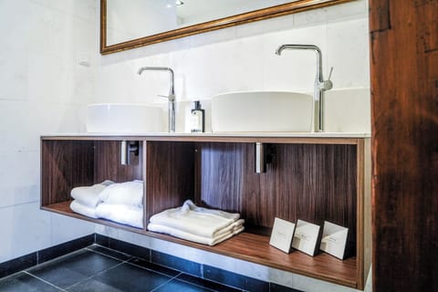 Executive Suite | Bathroom | Designer toiletries, hair dryer, bathrobes, slippers