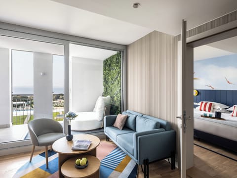 Family Suite, 2 Bedrooms, 2 Bathrooms, Partial Sea View | Living area | 30-inch LCD TV with satellite channels, TV, toys