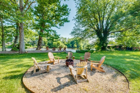 Back yard Oasis! Featuring a wood fire pit and wall right on the rivers edge!
