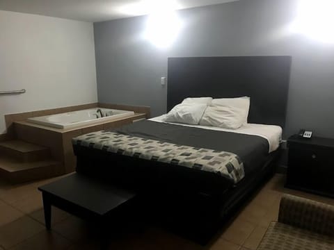 Standard Room, 1 King Bed (Jetted Tub) | Iron/ironing board, bed sheets