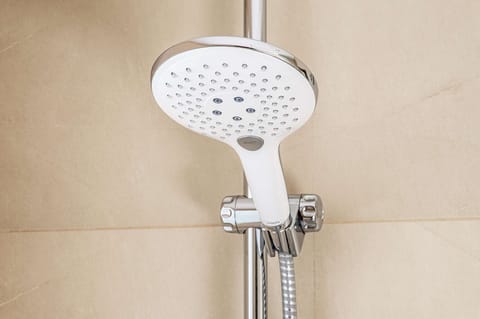Deep soaking tub, rainfall showerhead, eco-friendly toiletries