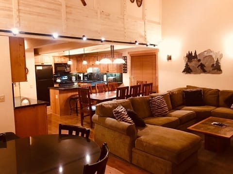 Main level living room, dining area, kitchen, game table.