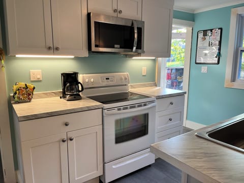 Nice new kitchen cabinets, Range and microwave with under cabinet lighting
