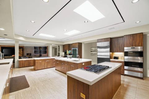 Gourmet kitchen has 4 separate kitchen islands, 4 refrigerators, 2 cooktops, 4 ovens &2 dishwashers