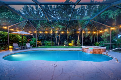 Spacious screened-in pool and spa surrounded by nature—your private outdoor escape
