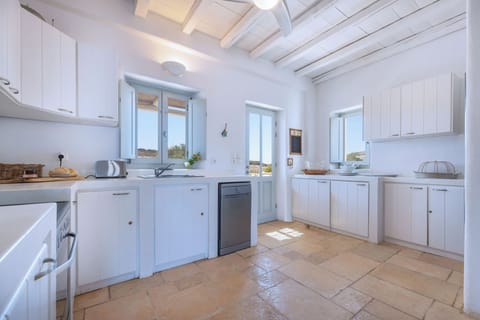 Fully equipped kitchen leading to back garden, grill area and Villa entrace. 
