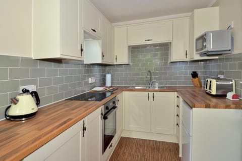 Kitchen is equipped with plenty of utensils, cutlery and crockery