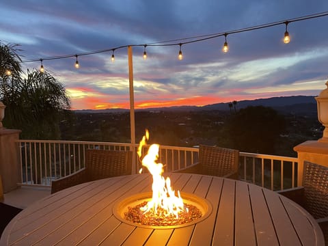 Gas fire pit w/ six comfy swivel chairs overlooking the pool, mountains, sunsets