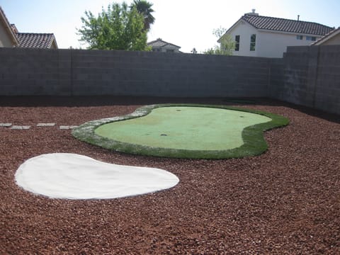 Backyard putting green with chipping area and sand trap