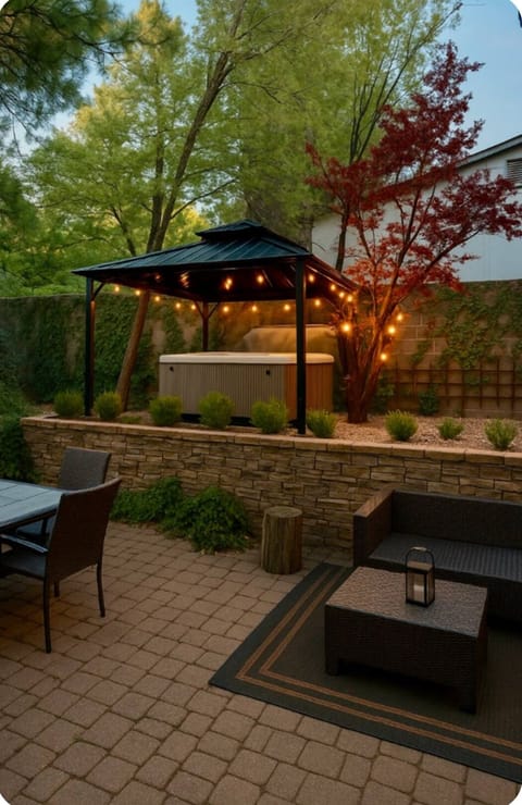 Gazebo and spa with twinkle lights.