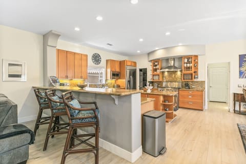 The granite countertops include bar-height dining with seating for three.