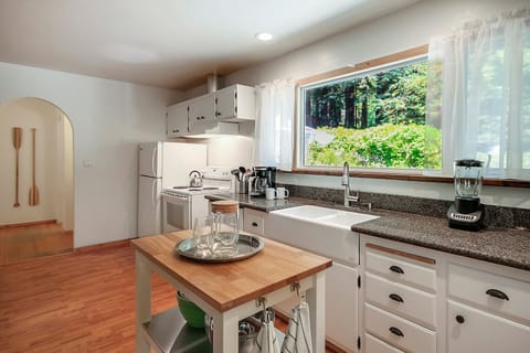 A farmhouse sink and new countertops grace the kitchen.