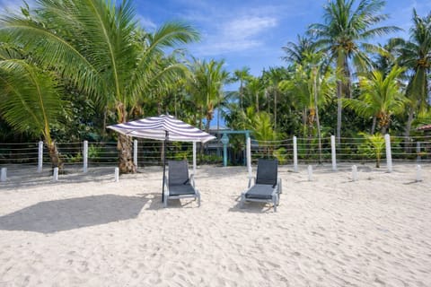 Front of the house on the beach. Chairs can be brought out with umbrellas