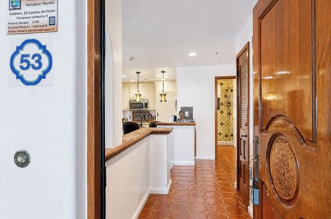 Welcome to unit 53, where beautiful tile floors greet you at the entrance and guide your way into the stylish kitchen and dining spaces beyond.