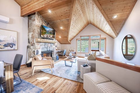Spacious main living area with vaulted ceilings, gas fireplace — ideal for group gatherings