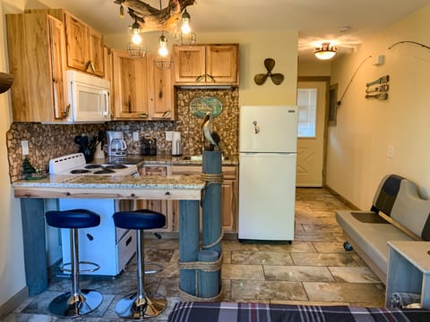 Features a full kitchen and seating for 2