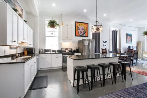 Bright, spacious kitchen with 6-seat island is open to dining and  living areas.