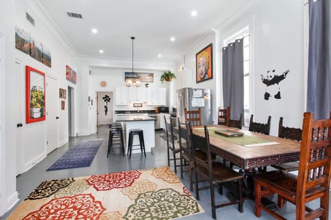 Dining table looking toward kitchen and island, half bath isn on left wall.