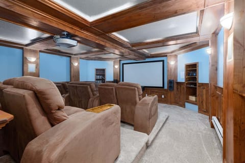 A ceiling-mounted projector, a wall-sized screen and twelve reclining seats in tiered rows. It is set up for streaming, and a DVD library for the evenings when nobody can remember their password. Everyone will love it!