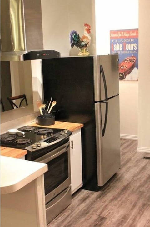 Kitchen showing the Oven/Stove and Refrigerator. Washer/Dryer in corner.