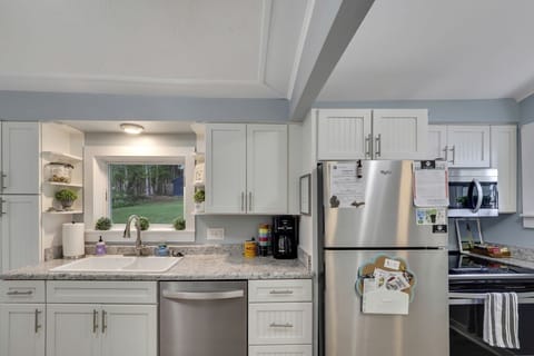 kitchen stocked with typical items: pots pans, dishes, take out items/etc