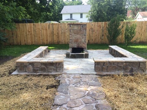 Newly constructed flagstone patio and sitting walls around historic 1910 firepit