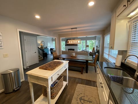 Updated kitchen with LVP flooring, new stainless steel appliances and farm table