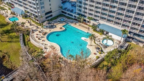 Exterior rear of property. Pool area with seating and view of Lake Bryant
