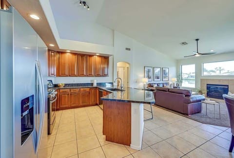 Experience comfort and style in this open-concept kitchen and living space. Featuring granite countertops, stainless steel appliances, and a cozy living area with ample natural light and modern furnishings.