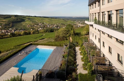 Seasonal outdoor pool, open 8:30 AM to 9 PM, pool umbrellas