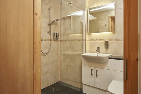 Deluxe Quadruple Room, 1 Bedroom | Bathroom | Combined shower/tub, free toiletries, hair dryer, towels