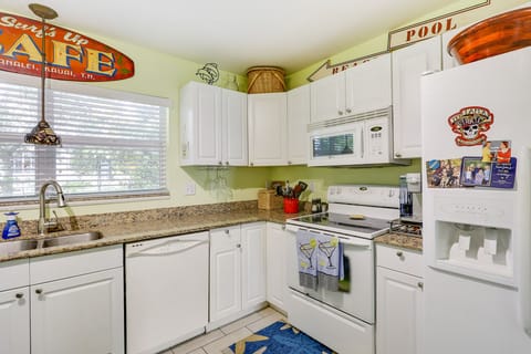This Kitchen is well stocked with dishes, cooking utensils & appliances 