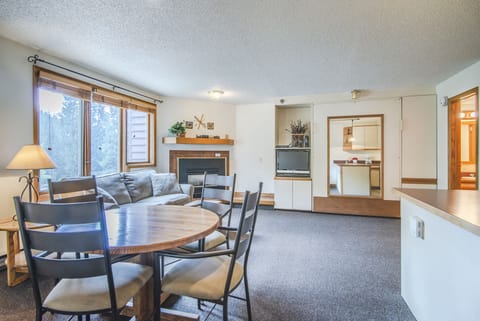 Open Floor Plan - Dining table and seating for four, queen sofa sleeper, queen murphy bed, and private balcony.
