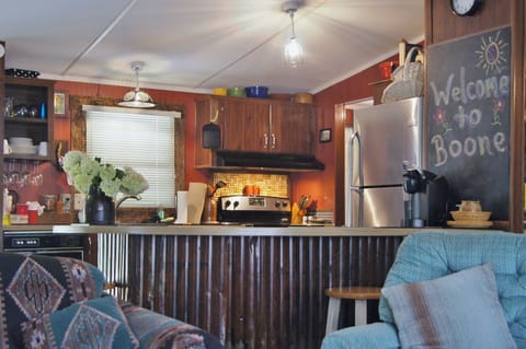 View toward kitchen with amenities like wine glass rack, cork thingy and sink!