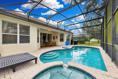 Private pool of the home in Kissimmee, Florida - Experience exceptional privacy while swimming in your exclusive glass-covered pool - Elevate your dining experience with poolside dining table, perfect for unwinding under the sun or stars