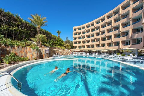 Outdoor pool, pool umbrellas, lifeguards on site
