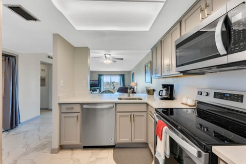 Quartz countertops with breakfast bar overlook the Living room and the beach.