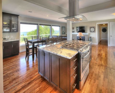 Gather round this lovely kitchen while gazing out the window at the water